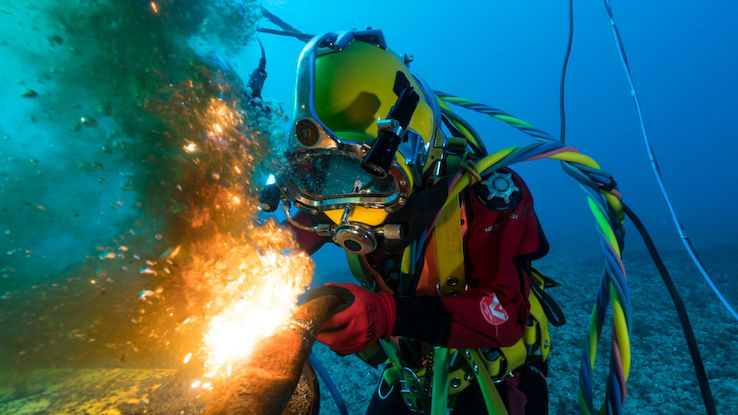 A diver welding underwater at a depth of 65 feet.